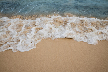 Seascape. Foam waves at sandy beach. Waterscape for background. Soft focus. Motion waves. Copy space. Bingin beach, Bali, Indonesia
