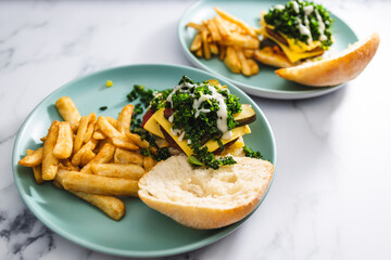plant-based food, vegan burgers with bean patty kale and dairy free cheese with a side of chips