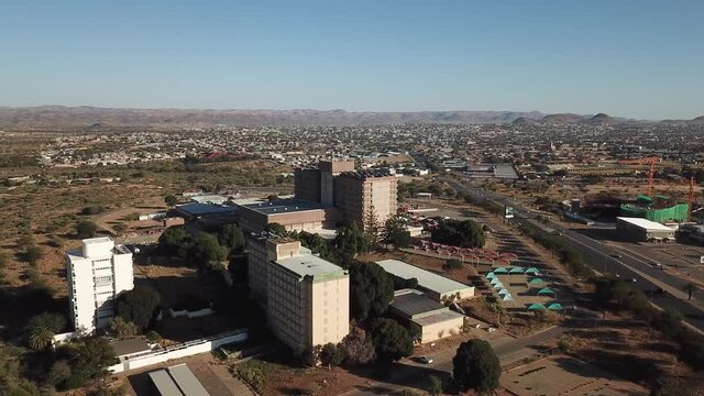 4K aerial drone summer sunny day video of Windhoek Katutura suburb large state hospital near B1 main highway in Namibia's capital in central highland Khomas Hochland of Namibia, southern Africa