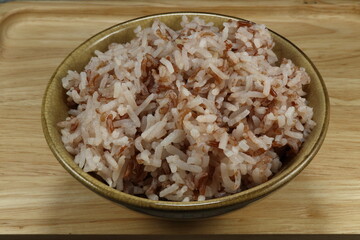 Cooked mixed brown rice on the bowl. Famous fusion of jasmine and brown rice in Asia restaurant. Carbohydrate and fiber menu concept. 