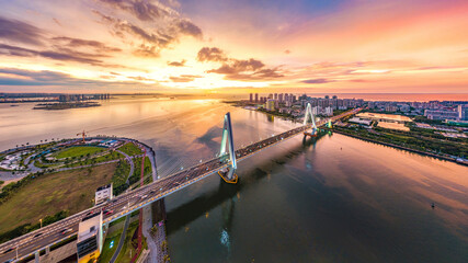 Haikou, Hainan, China Cityscape with Century Bridge, the Cross-sea Cable Stayed Bridge Connecting Downtown Haikou City and Haidian Peninsula Area. Evening Twilight Scenery with Blured Sky and Light.