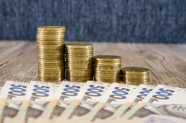 stacks of coins and 500 hryvnia on the table. Concept of savings, economy.Coins in order of growth