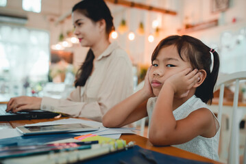 Mother and child do activities at home. Mother forced children to do homework and study online at home. During a viral epidemic, Covid-19 Concept: Mother and son stay at home to work and study.