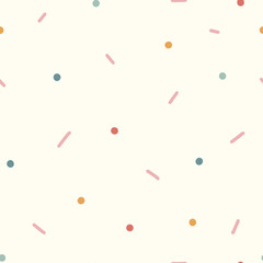 Seamless background of dots and dashes. Soft, cozy colors. Vector seamless pattern, can be used for fabrics, wallpaper, web, wrapping paper, card and more.