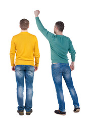 Back view of two man in sweater pointing.