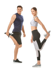 Obraz na płótnie Canvas Sporty young couple training on white background