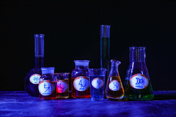 Potions with alchemical symbols on table