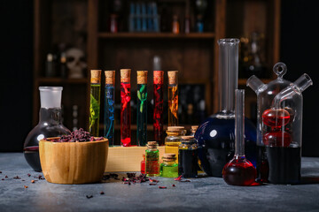 Different potions on table in alchemist's laboratory