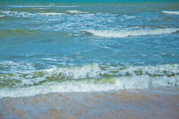 Tropical sea,Beach with Summer time. Close-up photo of beautiful beach with crystal clear turquoise water . Green and sky sea and the waves . Summer vacation background.