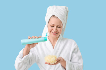 Beautiful young woman with shower gel on color background