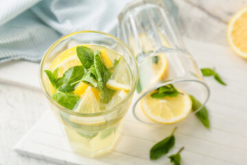 Glass of fresh lemonade on table