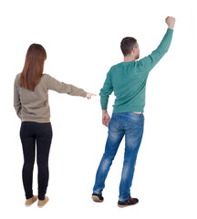 Back view of couple in sweater with mobile phone.