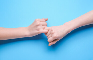 Pinky grip on color background. Unity concept