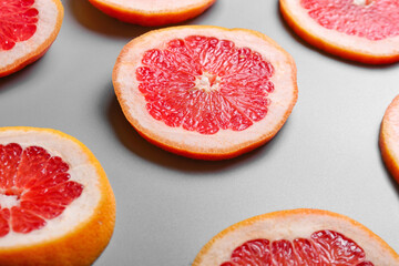 Fresh cut grapefruit on grey background