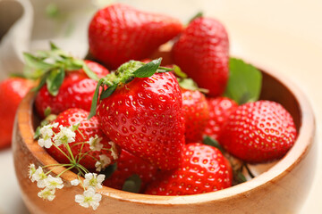 Bowl with ripe strawberry on table, closeup