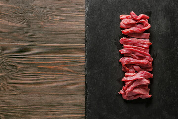 Pieces of fresh beef meat on table