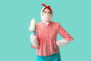 Fototapeta na wymiar Housewife in protective costume and with detergent on color background