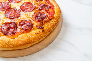 pepperoni pizza on wood tray