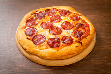 pepperoni pizza on wood tray