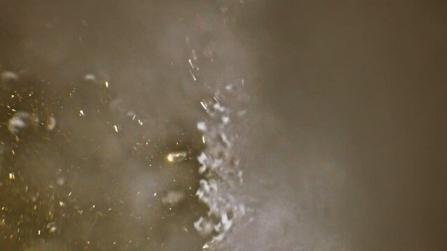 Video of underwater colorful bubbles rising to surface in slow motion 180fps. Close up, refreshing soda tonic fizzy water, bubbles dissolve in mineral carbonated drink. Bubbles particles rise up.