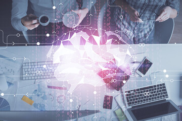 Double exposure of man and woman working together and human brain hologram drawing. Brainstorm...