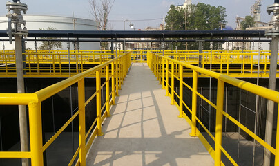 Walk way with yellow handrail inside factory