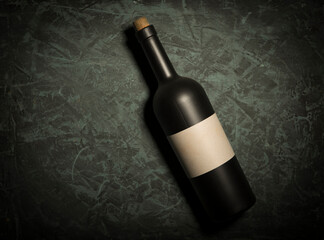 Glass bottle of wine with corks on wooden table background