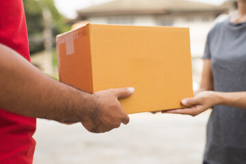 Hand accepting a delivery of boxes from deliveryman.