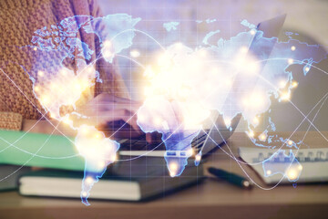 Double exposure of woman hands typing on computer and business theme hologram drawing. Success concept.