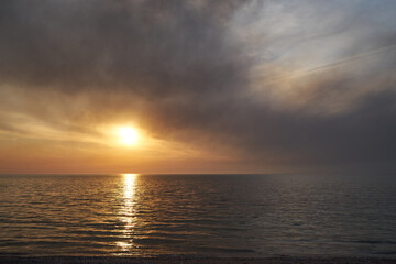 Sea sunset. Smoke wildfires sweeping across the sky.