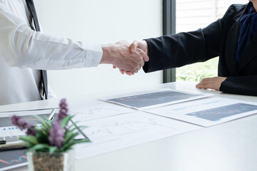 shaking hands, A team of business executives are planning consultations about business investments related to shares. By analyzing and calculating the stock market to find marketing profit