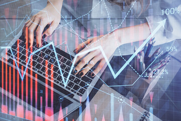 Double exposure of woman hands typing on computer and forex chart hologram drawing. Stock market invest concept.