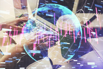 Double exposure of woman hands typing on computer and forex chart hologram drawing. Stock market invest concept.
