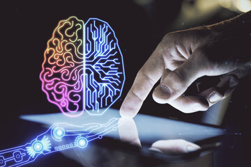 Double exposure of man's hand holding and using a digital device and brain hologram drawing. Data...