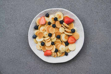 Freshly cooked pancake cereal served with fresh berries.