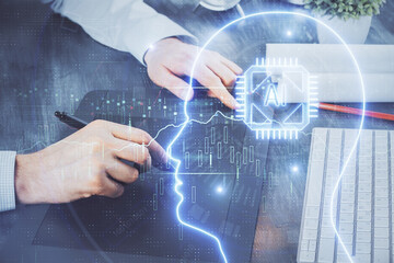 Double exposure of man's hand holding and using a digital device and brain hologram drawing. Data concept.
