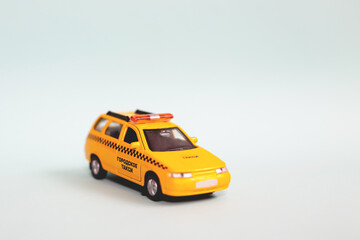 Fototapeta na wymiar Yellow taxi car model. idea, symbol, concept of urban service and delivery. Mobile online application concept.