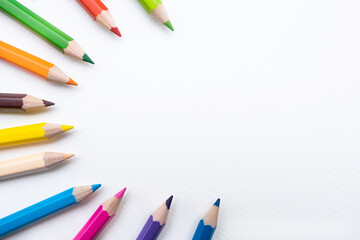 Top view of colourful crayons or colour pencil set in range isolated on white paper background.Back to school.