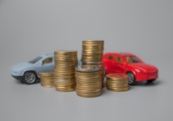 Mini car model with stack of golden coins,saving for car,loan and financial concept