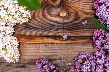 Bouquet of pink and white lilac on a old wooden background. Top view