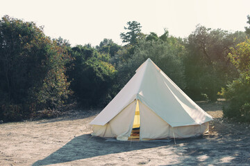 Glamping campsite in the forest. Big camping tent for luxury outdoor vacation. Staycations,...