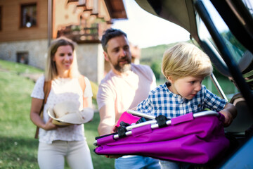 Family with small child going on trip in countryside.