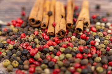 Cinnamon and spices in bulk lie on a dark wooden background.