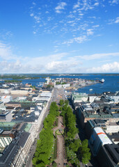 Scenic summer panorama of the Esplanadi park and Market Square Kauppatori at the Old Town pier in Helsinki. City center aerial view. Beautiful blue sky with clouds. Finland