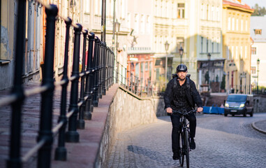 Front view of delivery man courier with bicycle cycling in town.