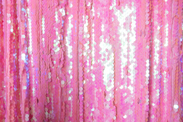 fabric of pink shiny sequins. textural background.