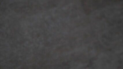 The background image of a black wall is blurred and out of focus.