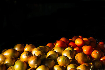 Tomatoes in a traditional market with a black background