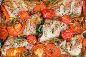 Background of the baked red perch with tomatoes and rosemary