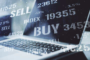 Multi exposure of abstract financial graph on laptop background, financial and trading concept